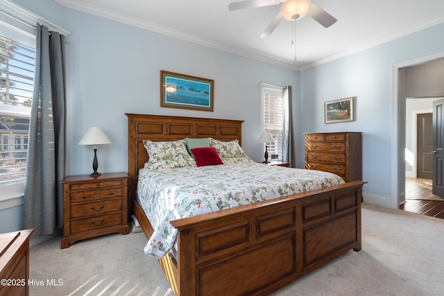 bedroom with crown molding, light colored carpet, and ceiling fan