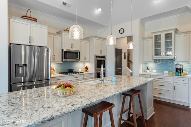 kitchen with sink, crown molding, decorative light fixtures, stainless steel appliances, and light stone countertops