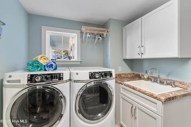 laundry room with cabinets, sink, and washer and dryer