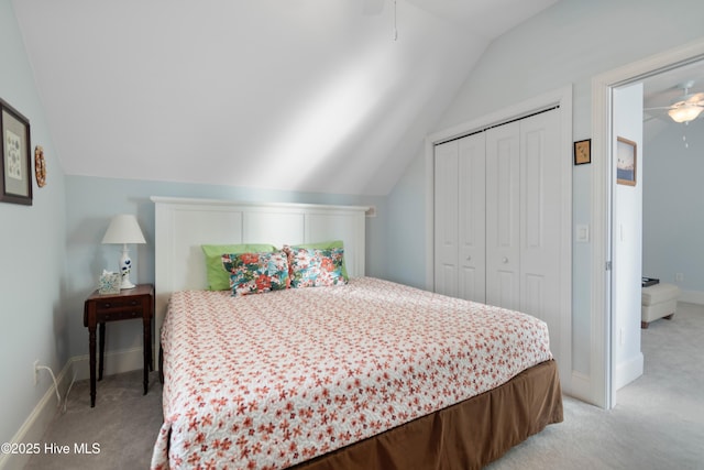 carpeted bedroom with vaulted ceiling, ceiling fan, and a closet