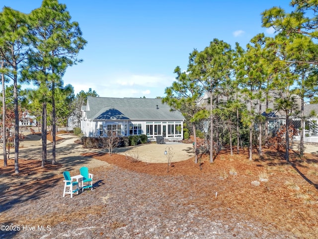 back of house featuring a sunroom