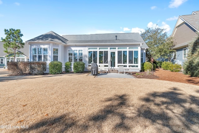 back of house with a yard and a patio area