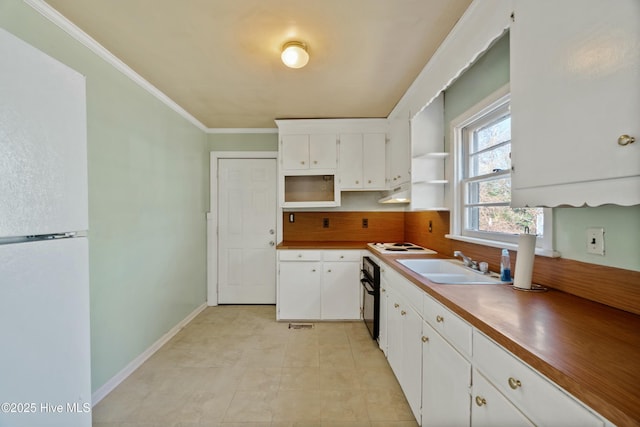 kitchen with white cabinets, white fridge, sink, wall oven, and crown molding