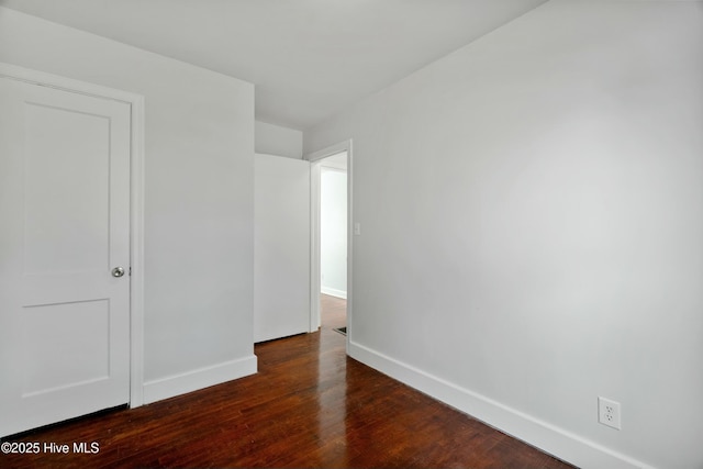 spare room with dark hardwood / wood-style floors