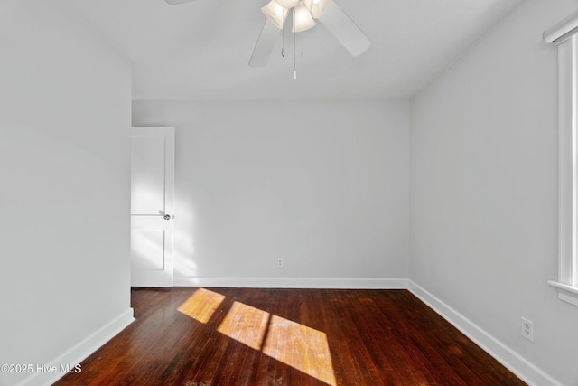 spare room featuring dark wood-type flooring and ceiling fan