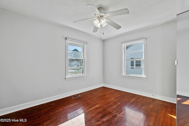 empty room with a textured ceiling, ceiling fan, and hardwood / wood-style flooring