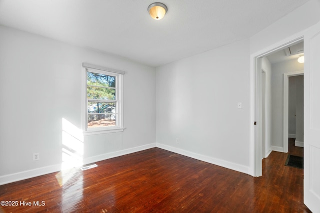 unfurnished room with dark hardwood / wood-style floors