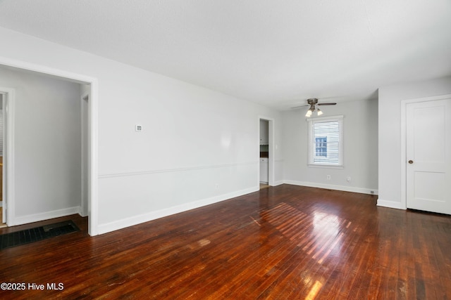 empty room featuring ceiling fan and dark wood-type flooring