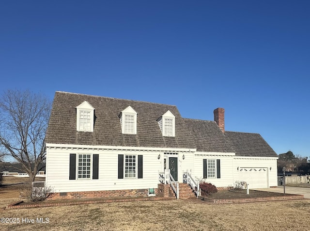 new england style home featuring a front yard and a garage