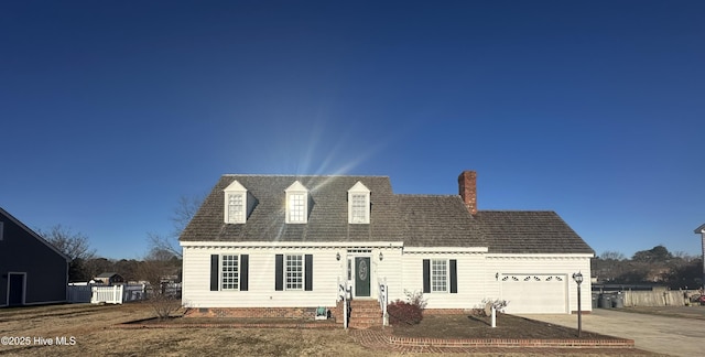 cape cod-style house featuring a garage, entry steps, and concrete driveway