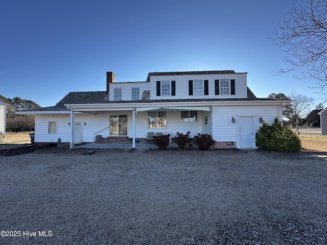 view of front of property featuring crawl space, a porch, and a chimney