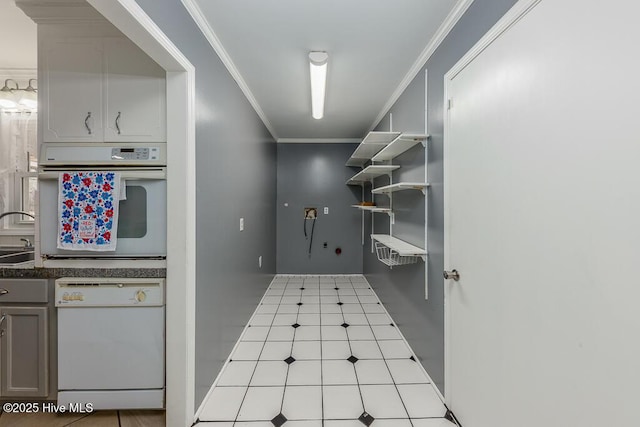 kitchen with white appliances, gray cabinets, crown molding, and sink