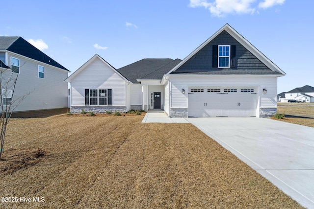 view of front of house featuring a garage and a front lawn