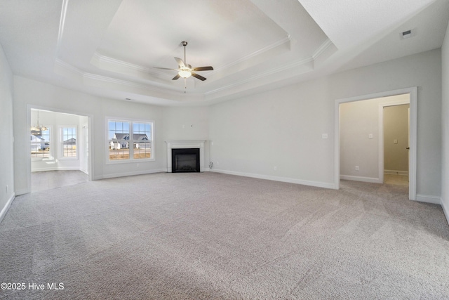 unfurnished living room featuring ceiling fan, light colored carpet, and a tray ceiling