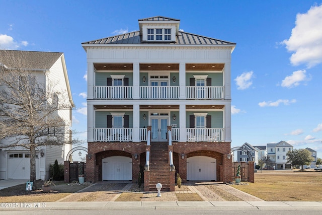 view of front of house featuring a garage, a balcony, and covered porch