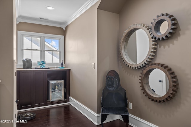 foyer featuring crown molding and dark hardwood / wood-style flooring