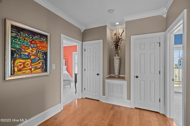 corridor featuring crown molding and light hardwood / wood-style floors