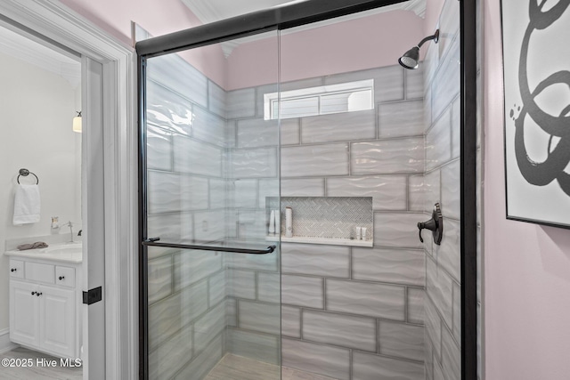 bathroom with vanity and a shower with door