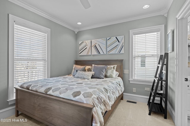 carpeted bedroom featuring ceiling fan and ornamental molding