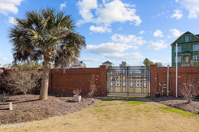 view of gate featuring a yard