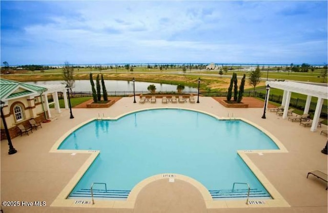 view of swimming pool with a pergola, a patio area, and a water view