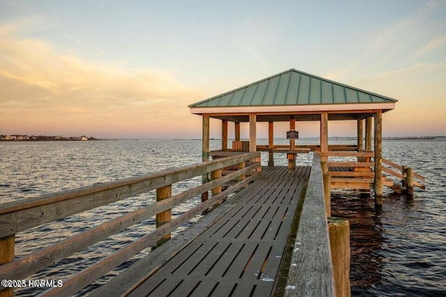 view of dock featuring a gazebo and a water view