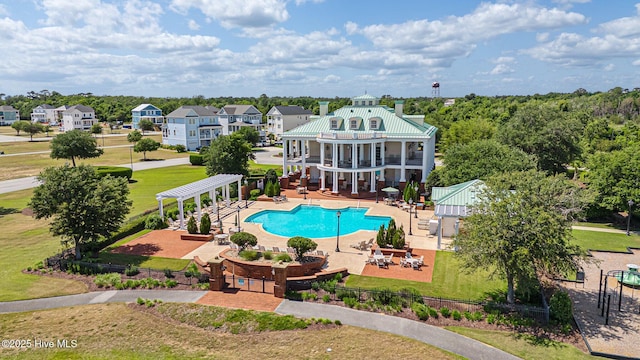 view of pool with a pergola, a patio area, and a lawn