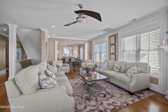 living room with ceiling fan, ornamental molding, dark hardwood / wood-style flooring, and decorative columns