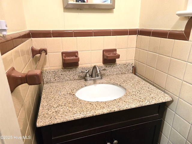 bathroom featuring tile walls and vanity