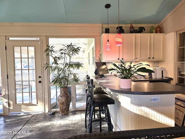 kitchen with decorative light fixtures and a kitchen bar