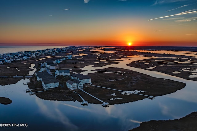 aerial view at dusk with a water view