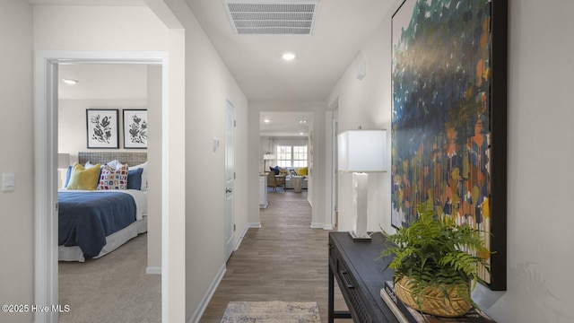 corridor with hardwood / wood-style floors