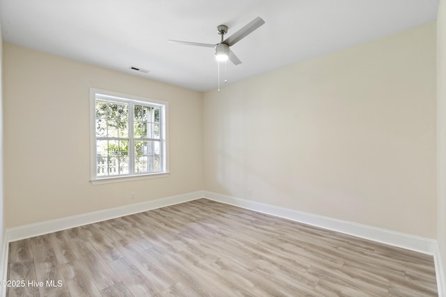 empty room with ceiling fan and light hardwood / wood-style flooring