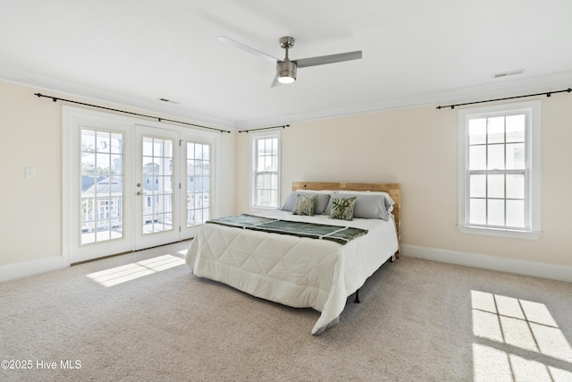 carpeted bedroom featuring ceiling fan, crown molding, access to exterior, and multiple windows