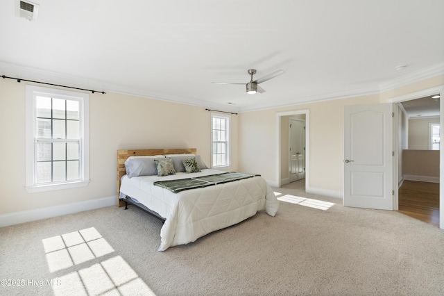 carpeted bedroom with ceiling fan, connected bathroom, and crown molding