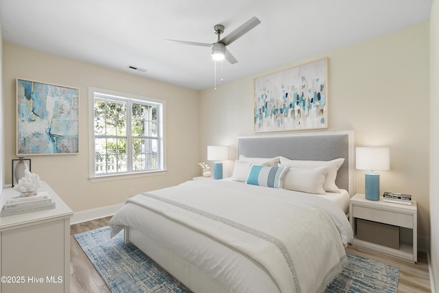 bedroom with ceiling fan and light wood-type flooring