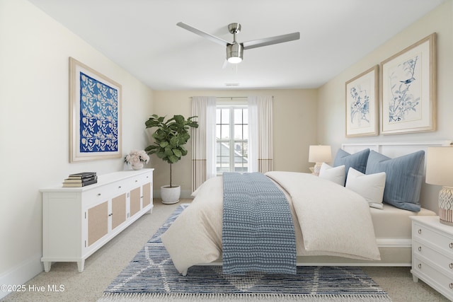 bedroom with ceiling fan and light colored carpet