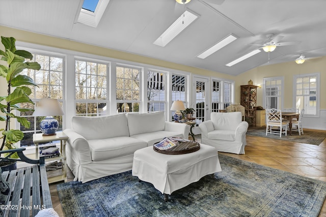 sunroom featuring ceiling fan, french doors, and lofted ceiling