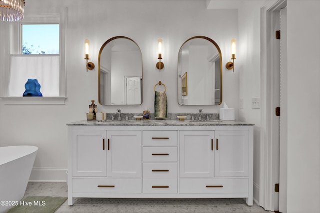 bathroom with vanity and a bath