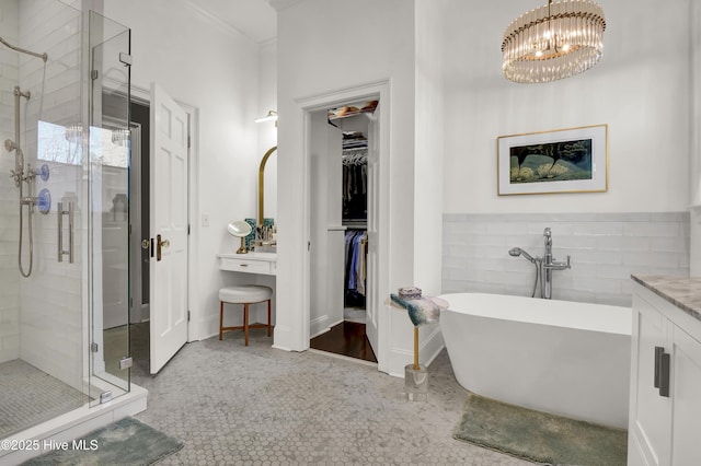 bathroom featuring vanity, tile patterned floors, crown molding, an inviting chandelier, and plus walk in shower