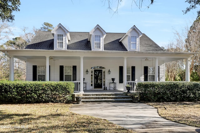 new england style home with a front yard and a porch