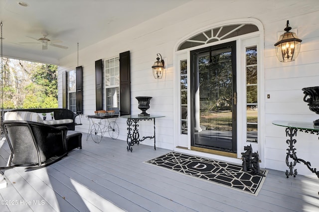 property entrance featuring covered porch, an outdoor living space, and ceiling fan