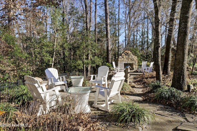 view of patio / terrace featuring an outdoor stone fireplace