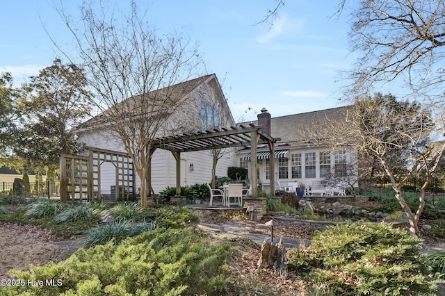 back of house with a pergola and a patio area