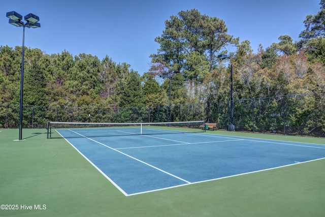 view of tennis court featuring basketball hoop