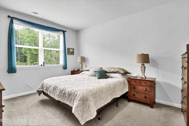 bedroom featuring light colored carpet