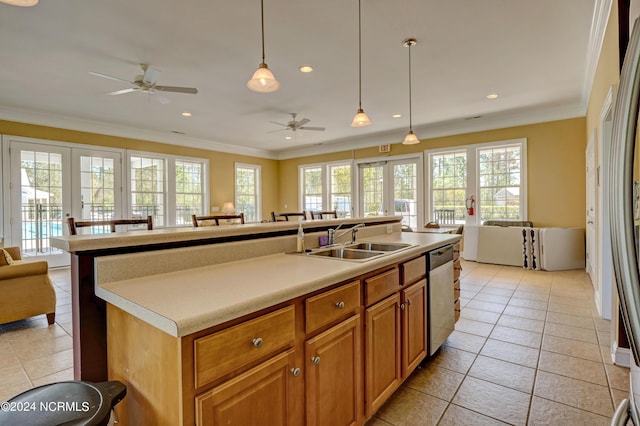 kitchen with dishwasher, decorative light fixtures, a kitchen island with sink, light tile patterned flooring, and sink