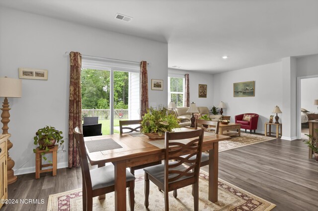 dining space with dark hardwood / wood-style floors