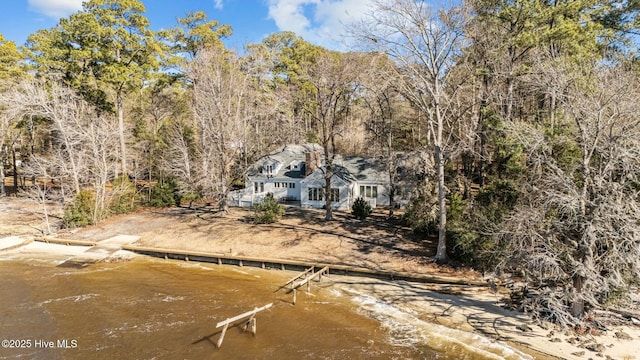 back of house with a water view