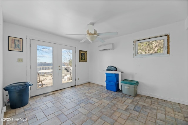 interior space featuring french doors, ceiling fan, a wealth of natural light, and an AC wall unit